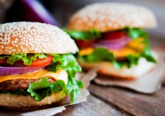 Closeup of home made burgers on wooden background Closeup of home made burgers on wooden background