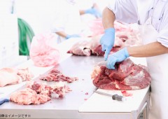 butcher cutting meat on the table