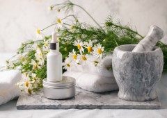 Concept of flowers and organic cosmetic. Essential camomile oil Concept of flowers and organic cosmetic. Essential camomile oil